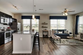 an open floor plan with a kitchen and living room  at Watermark on Twenty Mile, Parker